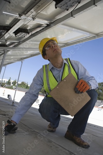 Photo: Maintenance worker checking solar panel in Los Angeles, California Maintenance worker checking solar panel in Los Angeles, California