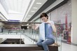 Young woman sits in new Voronezh shopping centre