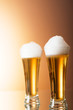 Beer glasses against the colorful gradient background Beer glasses against the colorful gradient background