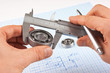 Technical drawing and callipers with bearing in hand Technical drawing and callipers with bearing in hand