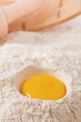 egg yolk in flour, rolling pin ang sieve on background egg yolk in flour, rolling pin ang sieve on background