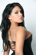 Female Model in a black corset with a White Background