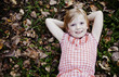 Photo: Cute Girl Laying in Fallen Leaves. Cute Girl Laying in Fallen Leaves.