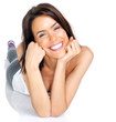 Smiling young woman lying on the floor