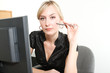 Business Woman in a Office with computer holding pen