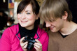 Girl and boy looking a fotos