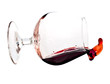 Red wine spilling from a transparent glass