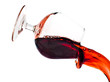 Red wine spilling from a transparent glass