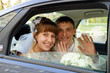 the couple in a wedding car