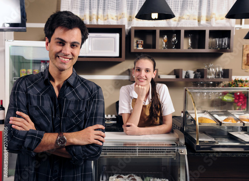 Photo: owner of a cafe and waitress owner of a cafe and waitress