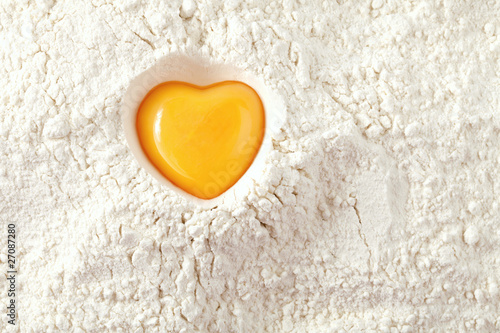 Photo: love to bake it! egg yolk on flour, full frame love to bake it! egg yolk on flour, full frame