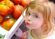 Hungry little girl gesturing in market tomatoes Hungry little girl gesturing in market tomatoes