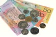 Australian banknotes and coins on plain white background