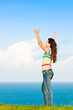 Beautiful young woman with her arms in the air