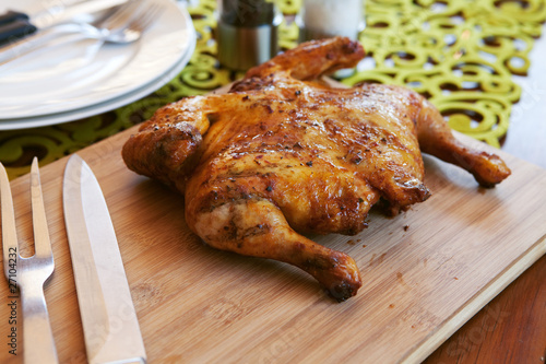 Photo: Whole cooked chicken with cutlery and spices Whole cooked chicken with cutlery and spices