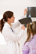 Young female doctor show x-ray to child Young female doctor show x-ray to child