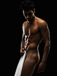 Photo: Sensuous macho man using white towel as a cover against black Sensuous macho man using white towel as a cover against black