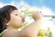 Child drinking pure water in nature Child drinking pure water in nature