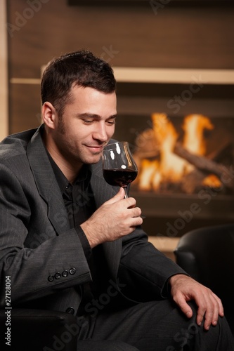 Photo: Man tasting wine at home Man tasting wine at home