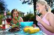Young Women Eating at a Barbecue. Model Released