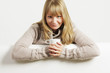 Smiling woman with white cup