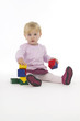 Little girl with wooden cubes.