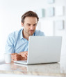 Relaxed young man using a laptop at home Relaxed young man using a laptop at home