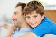 Happy young boy hugging his father