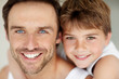 Happy young father and his son smiling