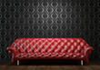 red leather couch on black wall