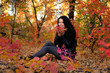 The girl brunette in autumn wood