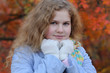 The young girl  in autumn wood