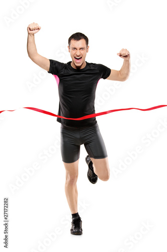 Photo: Full length portrait of a young runner at the finish line Full length portrait of a young runner at the finish line