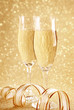 Two glasses of champagne and golden decoration
