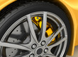 Front wheel of a bright yellow car Front wheel of a bright yellow car