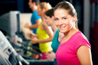 People in gym on treadmill running