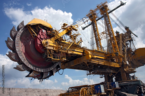 Photo: huge coal mining coal machine under cloudy sky huge coal mining coal machine under cloudy sky
