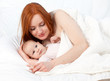 mother's love - baby 3 months boy with mother in bed mother's love - baby 3 months boy with mother in bed