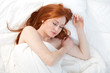 beautiful young woman relaxing in white bedding beautiful young woman relaxing in white bedding