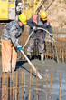 two builder workers at concrete works. Levelling and vibration