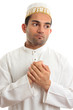 Ethnic man holding his hands to his chest