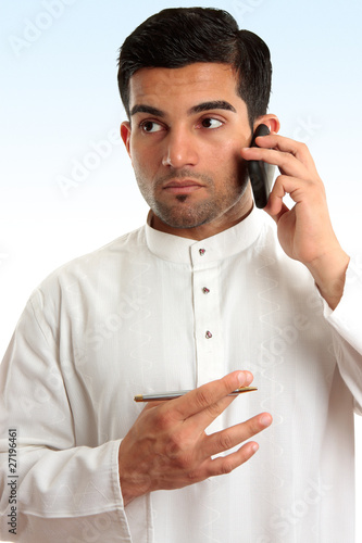 Photo: Ethnic business man using phone Ethnic business man using phone