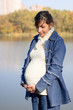 Pregnant woman near lake