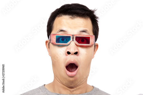 Photo: Young man with 3D glasses on watching a 3D movie . Young man with 3D glasses on watching a 3D movie .