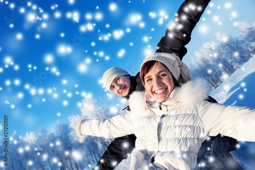 Photo: Happy smiling couple on a winter background Happy smiling couple on a winter background