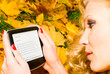 woman reading William Blake poetry in autumn forest