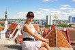 Young woman outdoors with city on background Young woman outdoors with city on background