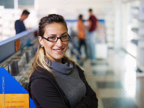 Photo: portrait of salesgirl in cd store portrait of salesgirl in cd store