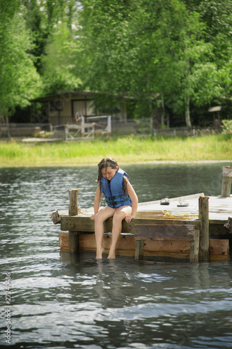 Photo: Young Girl Sitting On Dock Young Girl Sitting On Dock