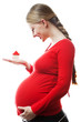 Image of pregnant woman keeping little house in her hand